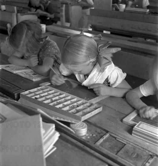 Girls doing writing exercice, letter case,  Dicken 1940