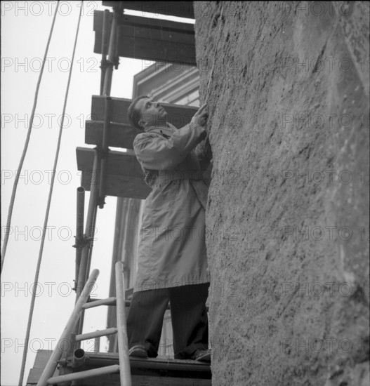 Man checking structural fabric of a building in Geneva 1943