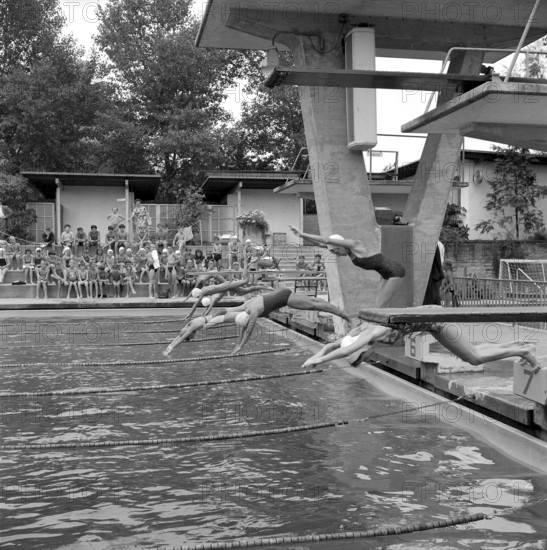 Zurich, gilrs taking a header during swimming lesson in a open air bath 1956
