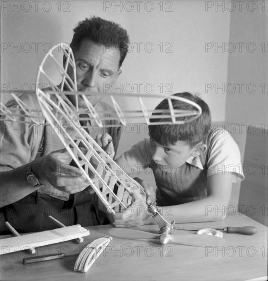 Father and son constructing a model aircraft, Stusslingen 1950