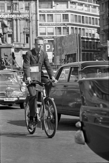 Posman, express messenger riding bicycle in Zurich 1966