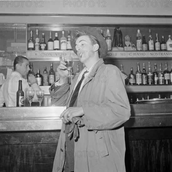 Young man drinking and smoking in a bar, Zurich 1951