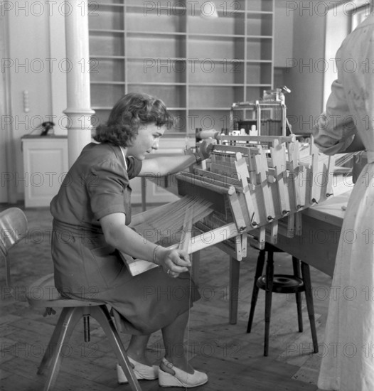 Woman at a loom at textile technical college Zurich 1949