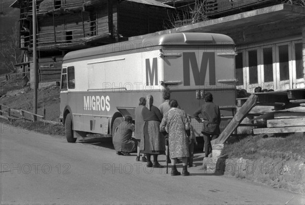 Customers waiting near Migros van, truck in Sarreyer VS, 1972