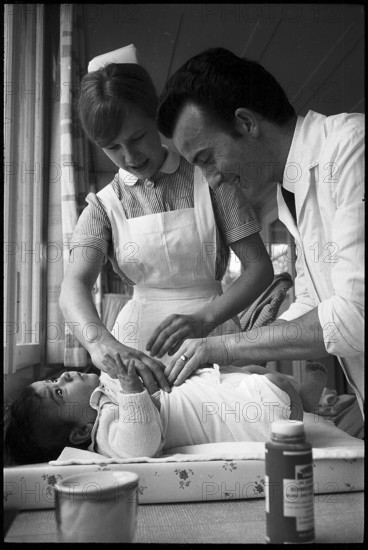 Man changing baby's nappies, 1969