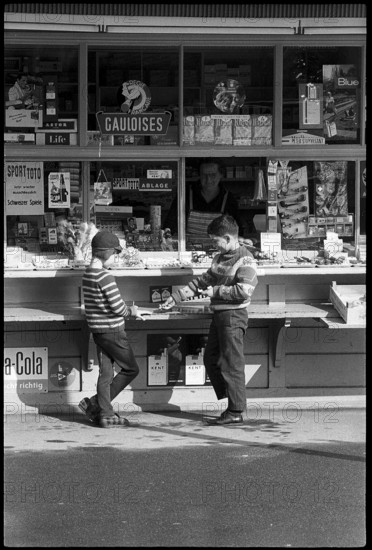 Boys buying sweets at a kiosk, Zurich 1966