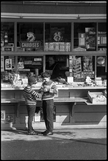 Boys buying sweets at a kiosk, Zurich 1966