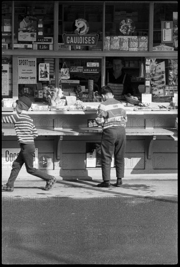 Boys buying sweets at a kiosk, Zurich 1966