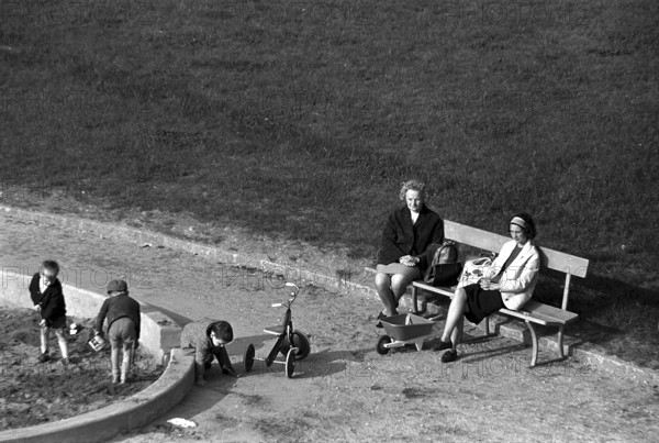 Women looking after children on a playground in Geneva 1966