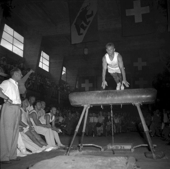 Swiss gymnastics day Burgdorf 1953: gymnast doing a horse jump