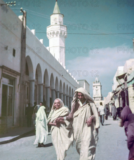 Leading blind person in street.