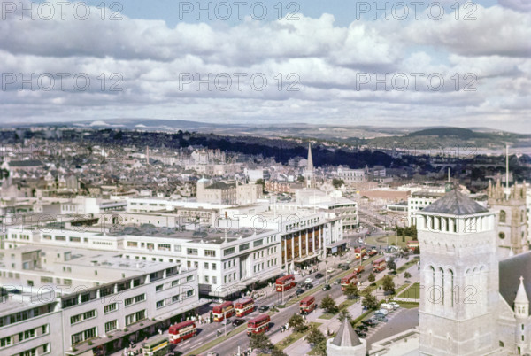 View over Royal Parade city centre street with red double decker buses.