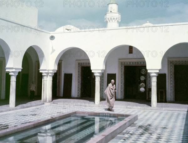 Arabic architectural style in courtyard with water pool.