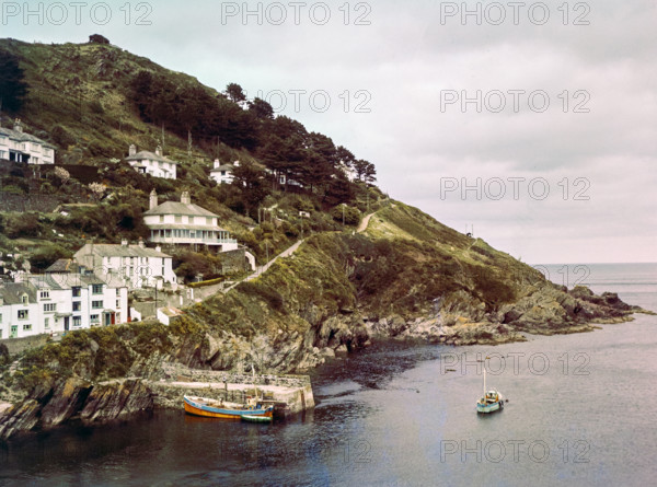 Historic waterfront buildings around the harbour river mouth of the River Pol at village of Polperro.