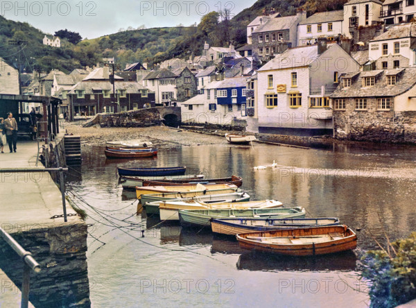 Historic waterfront buildings around the harbour river mouth of the River Pol at village of Polperro.