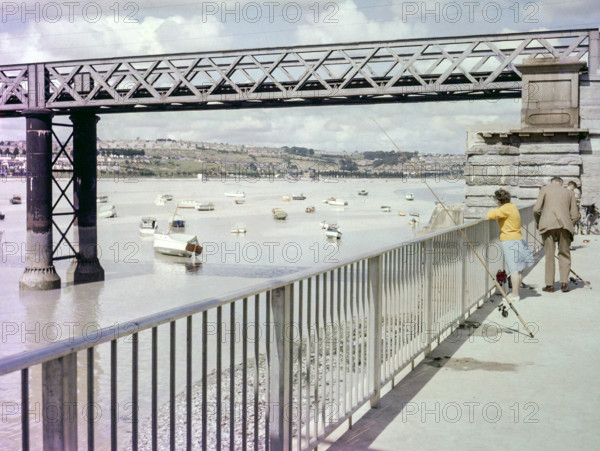 People fishing next to Laira Bridge railway bridge opened 1892.