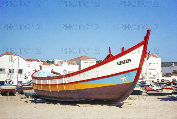 Traditional fishing boat on beach.