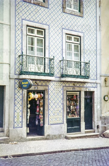 Typical Portuguese building facade with blue and white azulejo tiles shop selling film and souvenirs