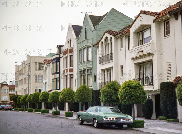 Mediterranean and Spanish Colonial Revival-style row houses stands in the Marina District of San Francisco, captured in 1976.
A dark green 1972 Chevrolet Impala