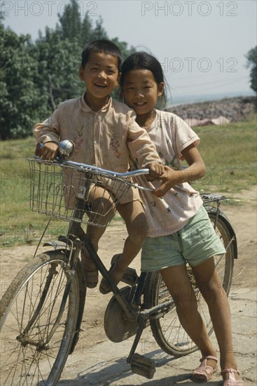 CHINA, Transport, Two children sharing an adult bicycle