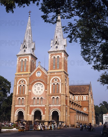 VIETNAM, South, Ho Chi Minh , "Notre Dame Cathedral,twin spires,rose window,street market,people "