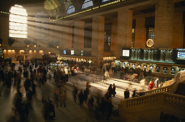 USA, New York State, New York, Grand Central station ticket hall at rush hour with light streaming through the windows