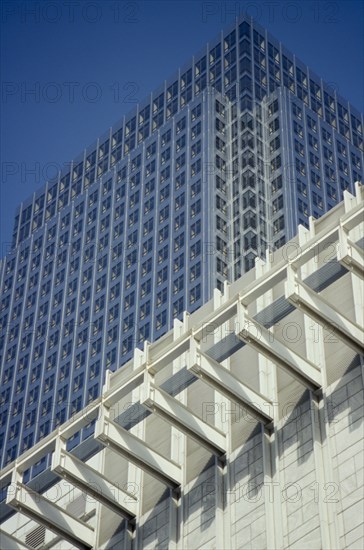 ENGLAND, London, Canary Wharf. Canada Tower rising over white building in the foreground