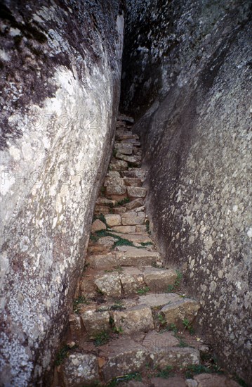 ZIMBABWE, Great Zimbabwe Ruins, Stone steps leading up a narrow stone walled alleyway