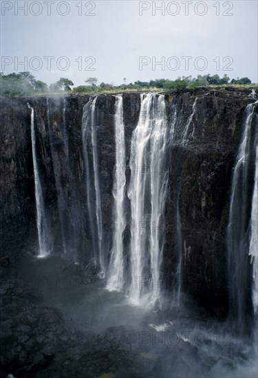 ZIMBABWE, Waterfall, Zambezi River Victoria Falls. Waterfall plummeting 355 feet over a sheer cliff face.