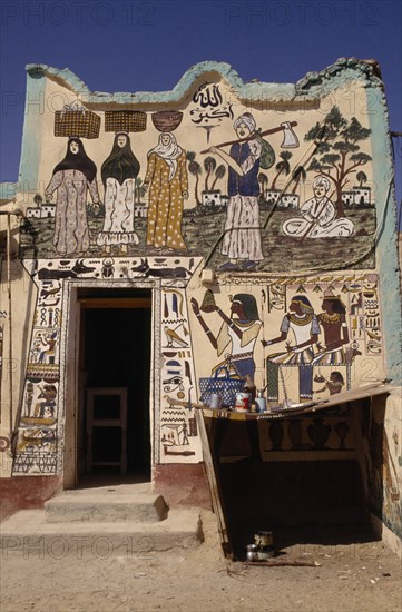 EGYPT, Luxor, House on West Bank of the Nile decorated with both Muslim figures and hieroglyphics