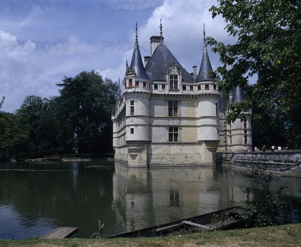 FRANCE, Loire Valley, Azay Le Rideau Chateau and Water filled Moat Bridge Boat Moared On Bank In Foreground