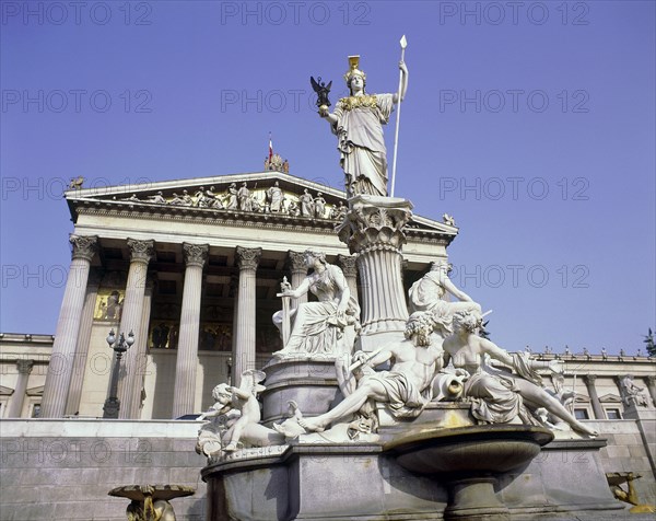AUSTRIA, Lower, Vienna, Parliament House with an ornate stone monument in the foreground