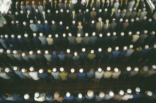 CHINA, Gansu Province, Lanzhou, View looking down on rows of praying Muslims in a Mosque on festival day to mark the end of Ramadan.