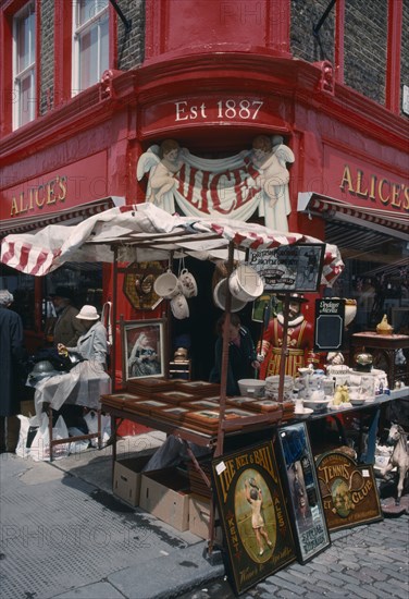 ENGLAND, London, Portobello Road antique shop in the market with a stall outside on the pavement