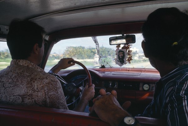 CUBA, Transport, Interior of car with image of Che Guevara hanging beneath front windowscreen mirror.