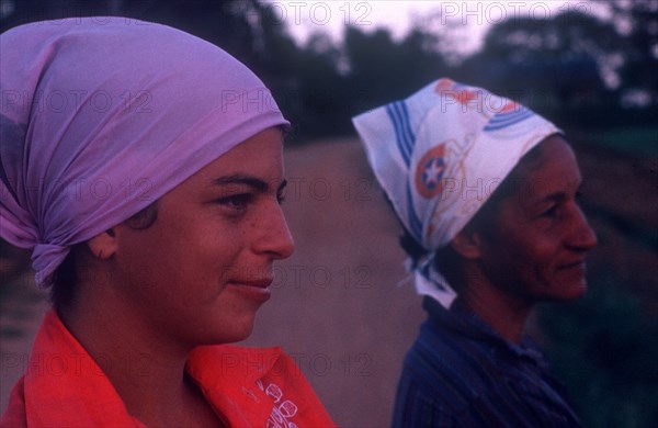 CUBA, Pinar del Rio, Close up of two women wearing head scarfs looking off to the right