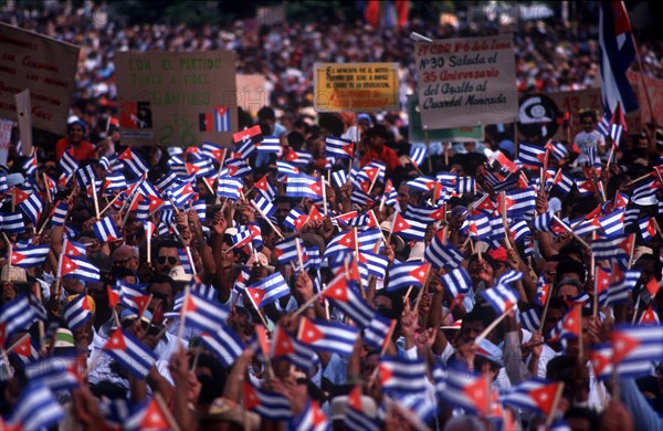 CUBA, Santiago, Crowds waving paper flags at the July 26th celebrations