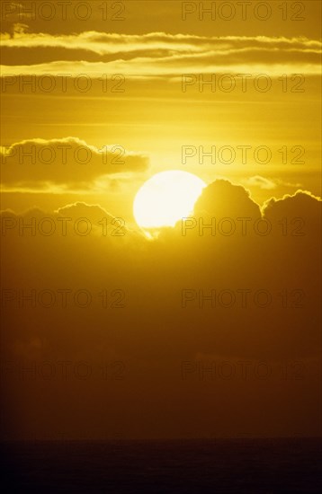 WEATHER, Climate, Sunset, "Golden sunset breaking through clouds over the sea at Hastings, East Sussex, England"