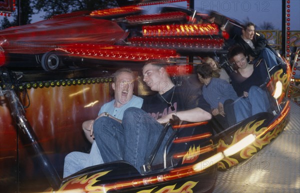 ENTERTAINMENT, Funfair, People on a funfair ride at night with movement blur