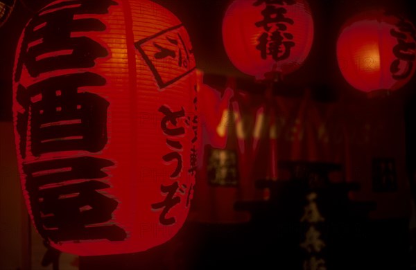 JAPAN, Honshu, Tokyo, Chochin Red Lanterns outside Izakaya Bar in Ichikawa district. Writing says Irrashaaimasen or Welcome.