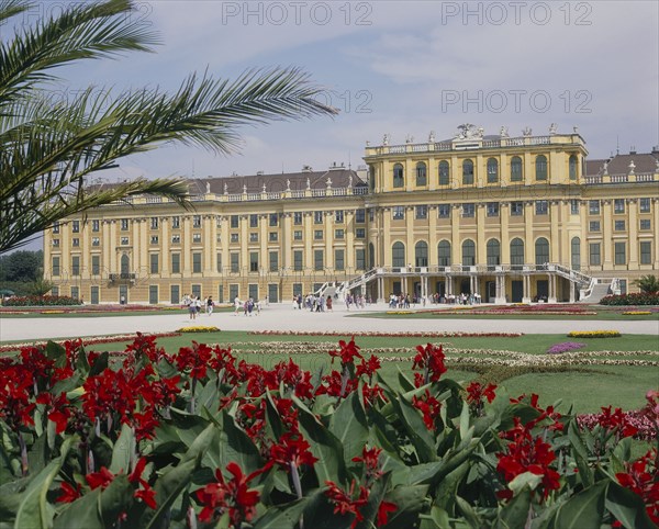 AUSTRIA, Lower Austria, Vienna, Schonbrunn Palace and formal gardens with a bed of red flowers in the foreground