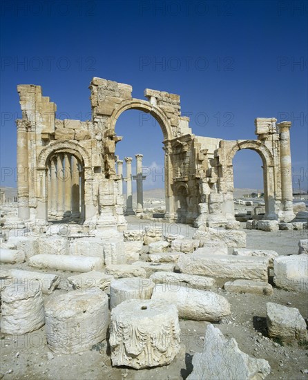 SYRIA, Central, Tadmur, "Palmyra monumental Arch remains, three arches,pillars behind,broken stone. "