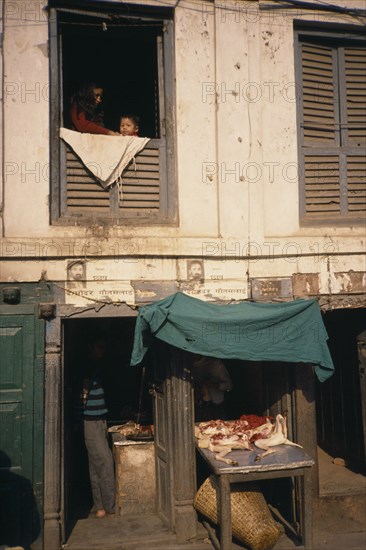 NEPAL, Kathmandu, Durbar Square butchers with display of goods and people at a window above