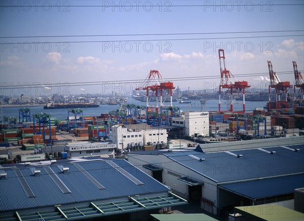 JAPAN, Osaka, Osaka Bay, "Aerial view over the docks with warehouses, containers, cranes and ships. "