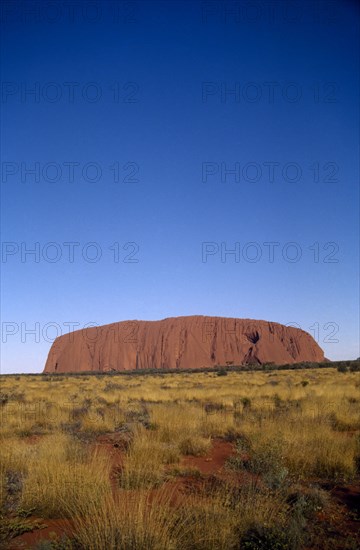 AUSTRALIA, Northern Territories, Ulhuru, Ayres Rock in desert landscape.