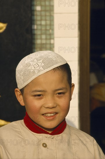 CHINA, Gansu, Lanzhou, Moslem boy wearing velvet beaded cap