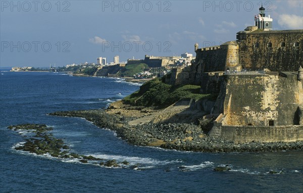 WEST INDIES, Puerto Rico, San Juan, View along San Juan coastline with fort and old city walls.