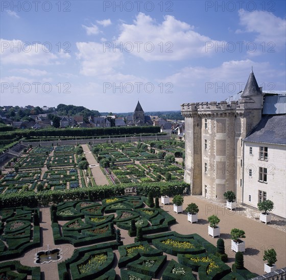 FRANCE, Indre Loire, Villandry, "View looking down across gardens and corner of chateau, blue and cloudy sky. "