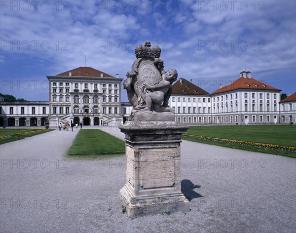GERMANY, Bavaria, Munich, Nymphenberg Palace. Approach path with statue on stone plinth in foreground