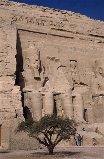 EGYPT, Nile Valley, Abu Simbel, Sitting statues of Ramses the second at the temple carved in to a sandstone cliff